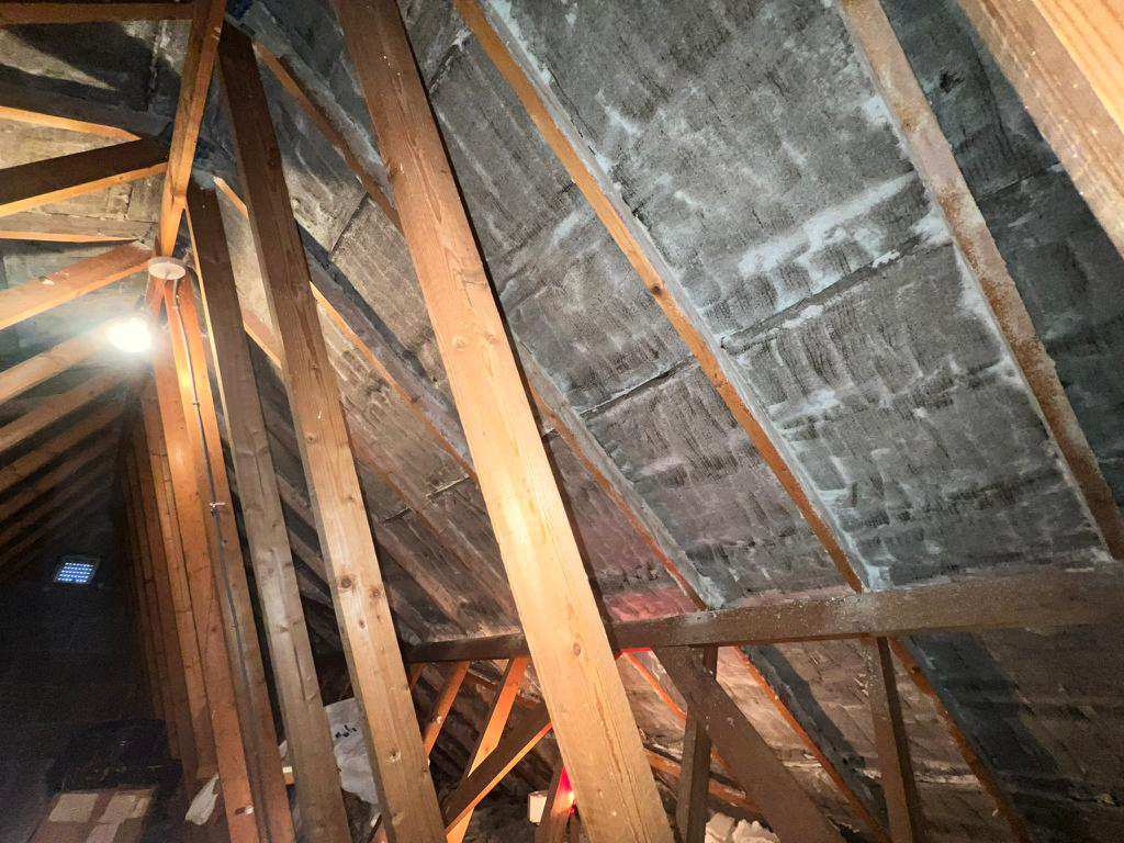 Loft after spray foam removal – clean timber rafters