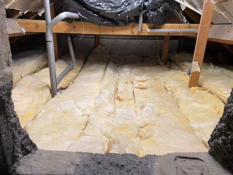 Mineral wool loft insulation laid between the joists
