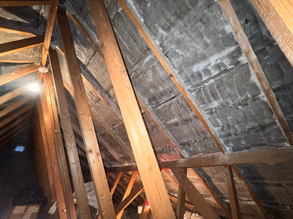 Loft after spray foam removal – clean timber rafters